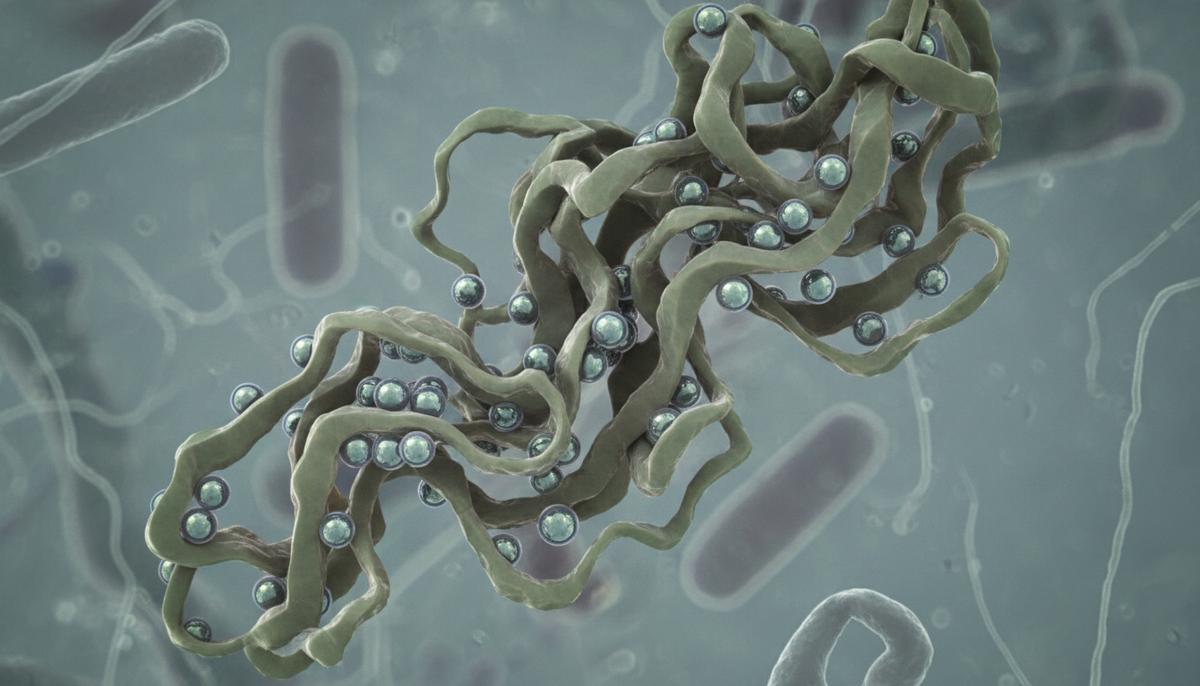 Микроскопическое изображение: сферические наночастицы прикрепляются к деформированной белковой цепи внутри клетки.