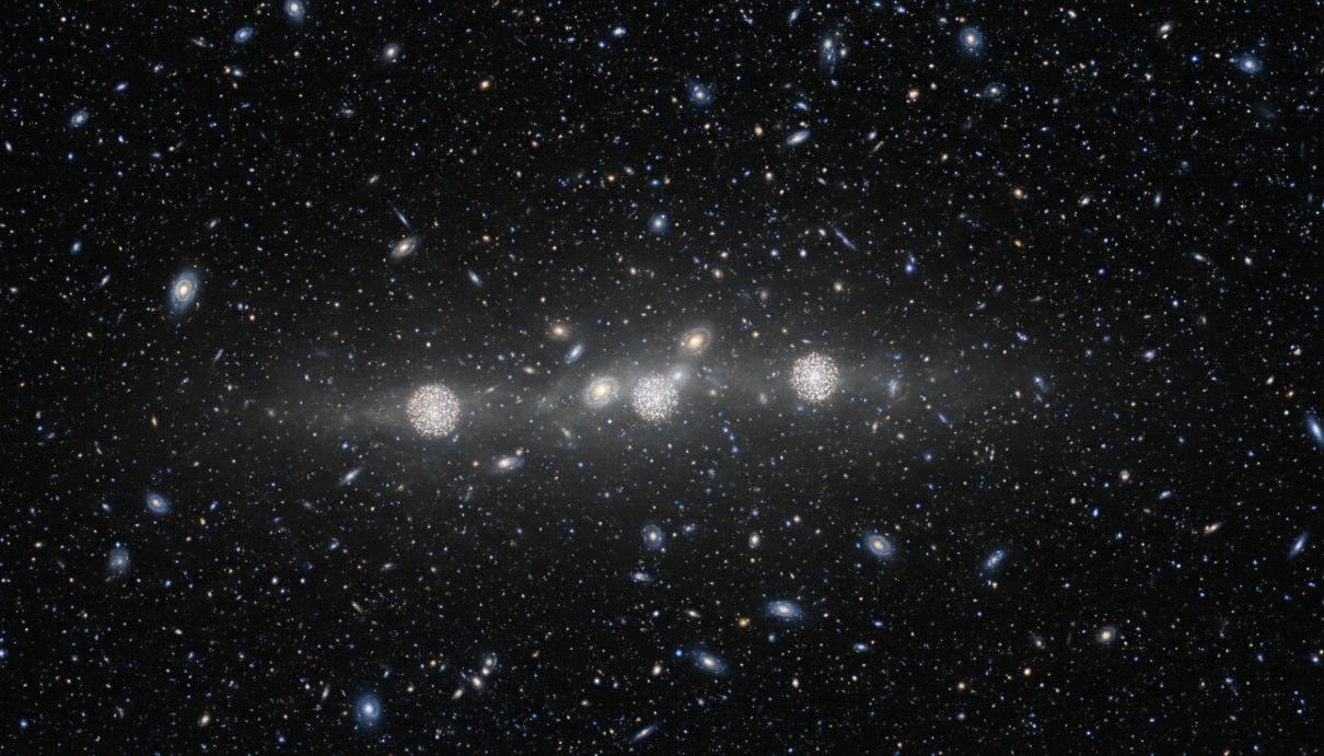 Тусклая призрачная галактика CDG-2 с четырьмя яркими шаровыми скоплениями на фоне скопления галактик в Персее.