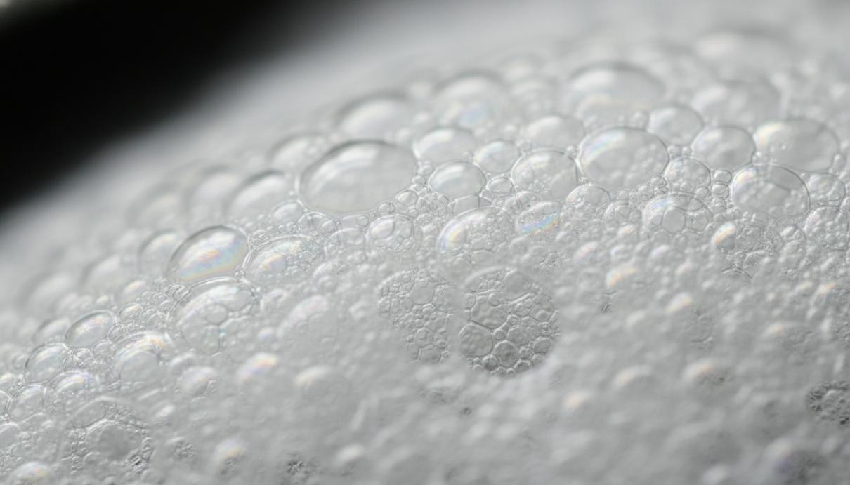 Макросъемка структуры пены с множеством плотно прилегающих друг к другу прозрачных пузырьков